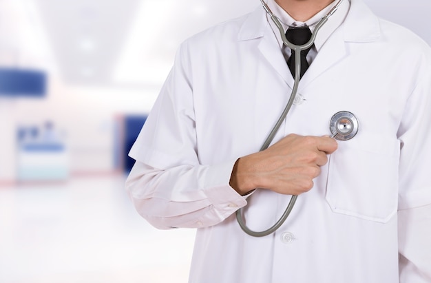 doctor listening his heart with stethoscope in hospital