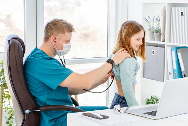 Doctor listening little girl