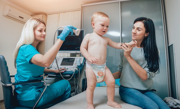 Doctor and little boy patient. Ultrasound equipment.