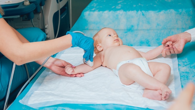 Doctor and little boy patient. Ultrasound equipment.