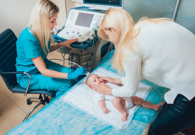 Doctor and little boy patient with her mother