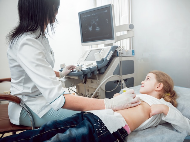 Doctor and little girl patient. Ultrasound equipment.