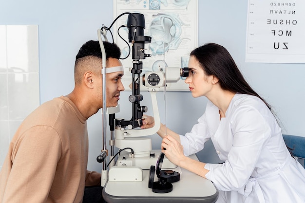 Photo a doctor looks at an eye exam with a patient.