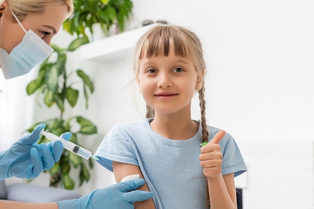 Photo the doctor makes a child vaccination.