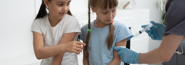 Photo the doctor makes a child vaccination.