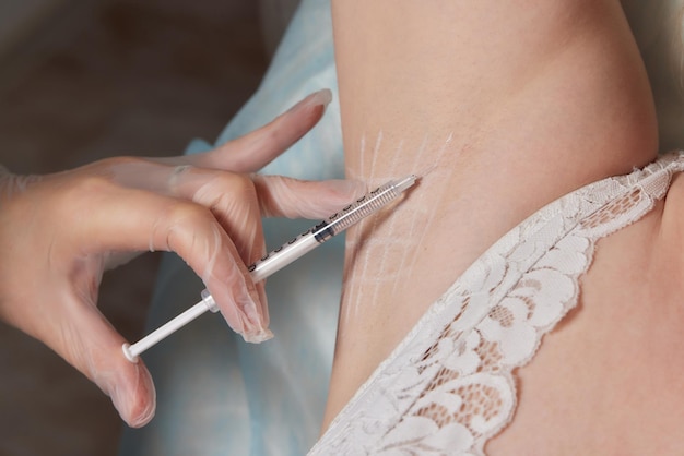 The doctor makes intramuscular injections of botulinum toxin