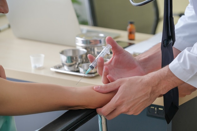 Doctor making an injection to a patient