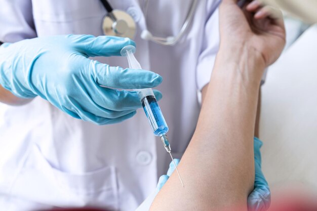 Photo doctor making injection vaccination patient to prevent pandemic of the disease flu or influenza virus in clinic