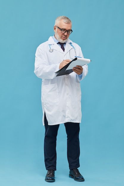 Doctor making notes in card