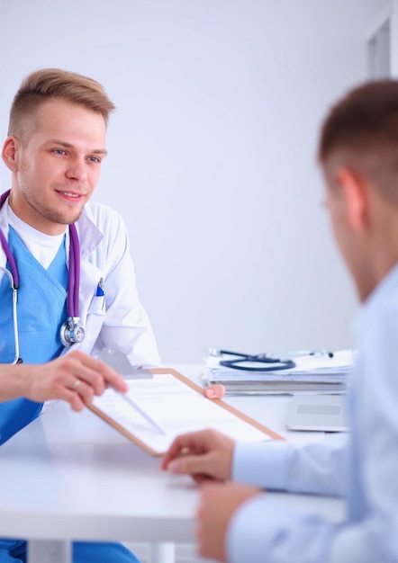 Doctor male giving patient folder with paper in her office isolated