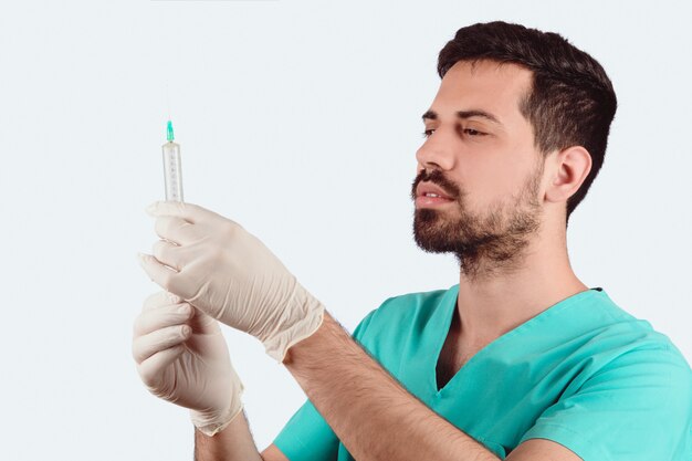 Doctor male holding syringe