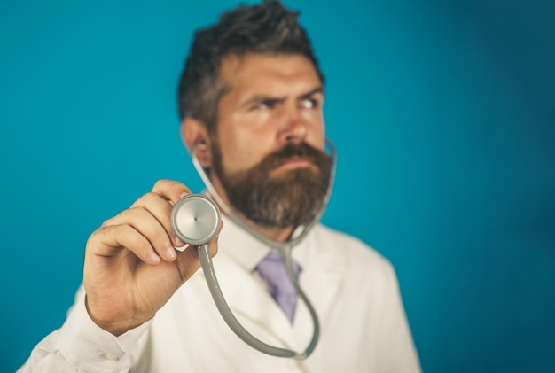 Doctor male physician with stethoscope in hand focus on stethoscope doctor holds in hand stethoscope