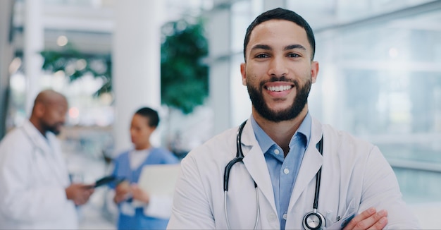 Doctor man and arms crossed with smile in portrait at hospital with pride for medical career Person happy and healthcare professional in corridor at clinic for wellness services and job in Mexico