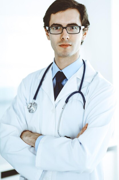 Doctor man cheerful smiling at camera, thumbs up. Perfect medical service in clinic. Happy future in medicine and healthcare.