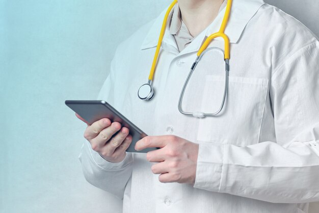 Doctor man holding a tablet with blue light