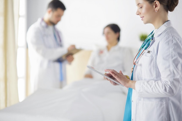 Doctor man in surgery examining young woman