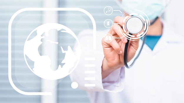 Doctor man wearing white coat standing holds his stethoscope on hand for listening