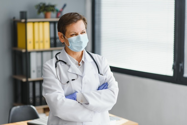 Doctor in mask with stethoscope in hospital