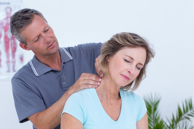 Doctor massaging his patient neck