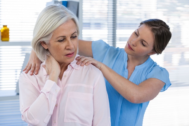 Doctor massaging a patient's shoulder