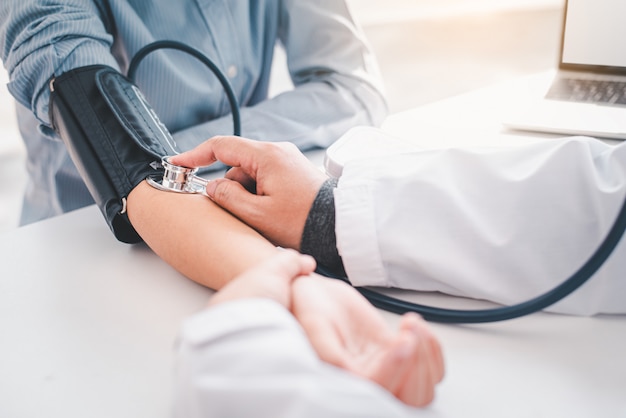 Doctor measuring blood pressure from the patient