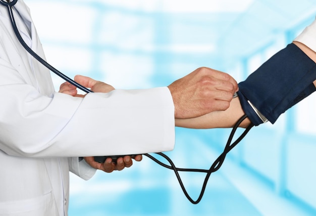 Doctor Measuring Blood Pressure Gauge to patient