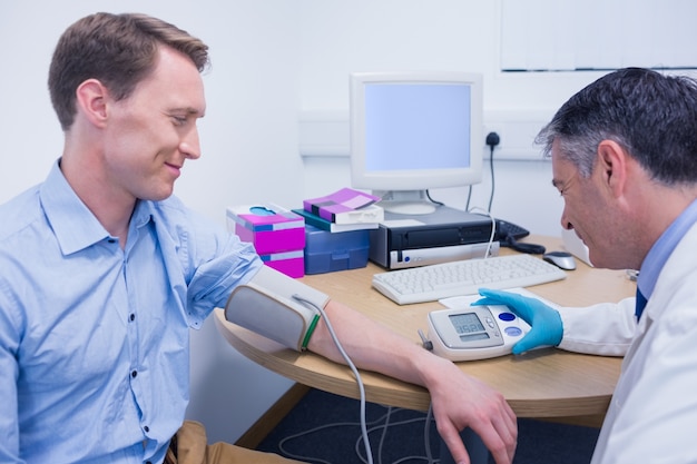 Doctor measuring his patients blood pressure