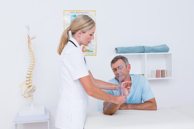 Doctor measuring wrist with goniometer 