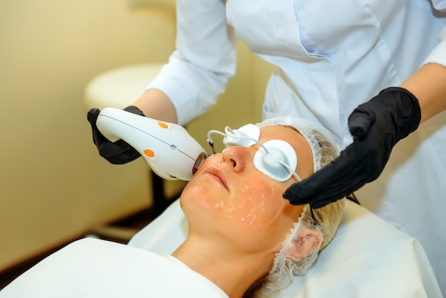 Doctor in medical gloves applies the patient special gel