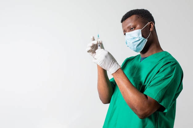 Doctor in medical mask holding syringe with medication