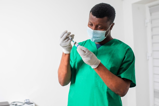 Photo doctor in medical mask holding syringe with medication