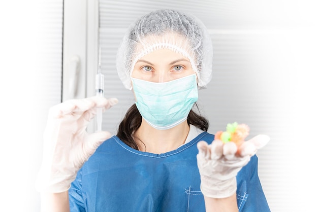 Doctor in medical uniform gloves and cap in hand hold syringe with vaccine and virus in lab