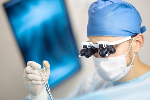 doctor microsurgeon works in the operating room in glasses microscope with lenses neurosurgical ope