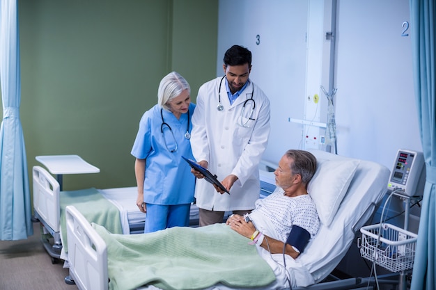 Doctor and nurse examining a patient