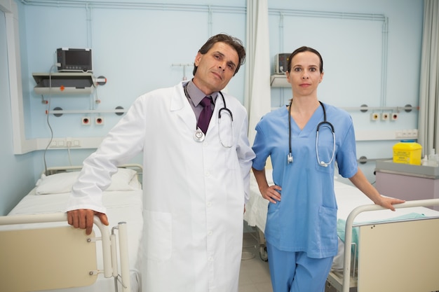 Doctor and nurse in hospital bedroom