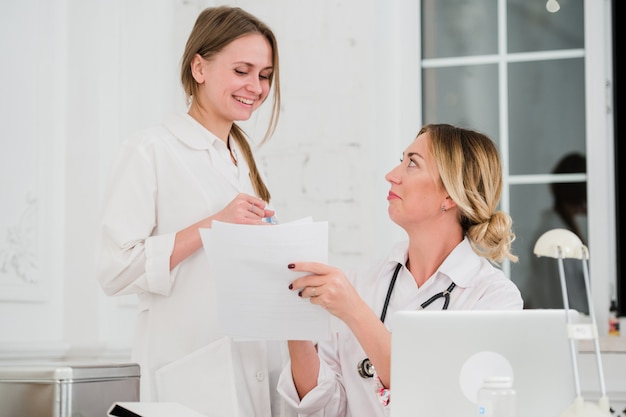 Doctor and nurse looking at docments in medical office