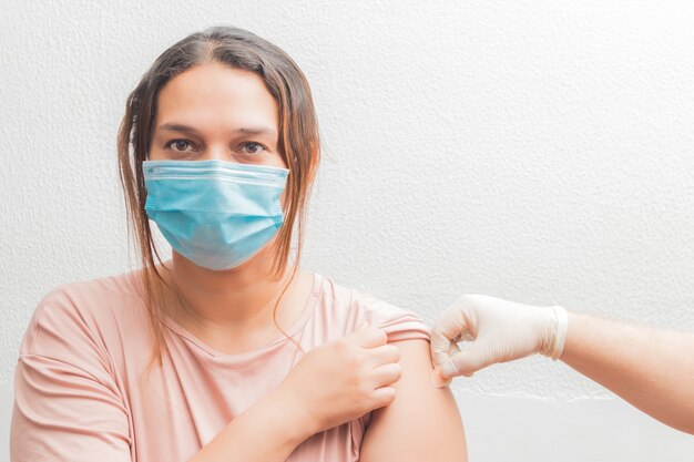 Doctor or nurse putting a cure to the patient with a medical mask where I inject it