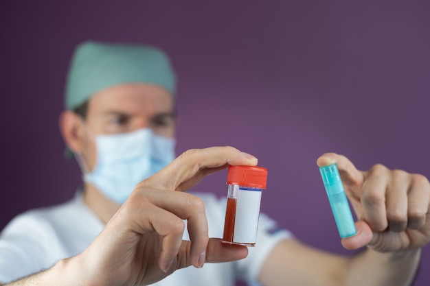 Doctor nurse showing a sample of Coronavirus or Covid-19 with face mask