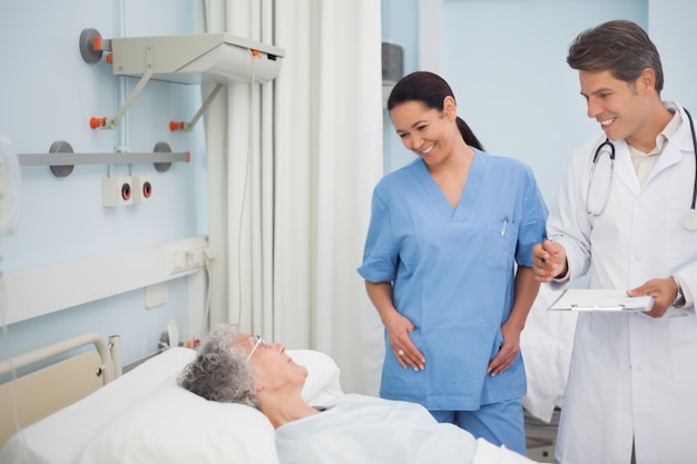 Doctor and nurse smiling to a patient