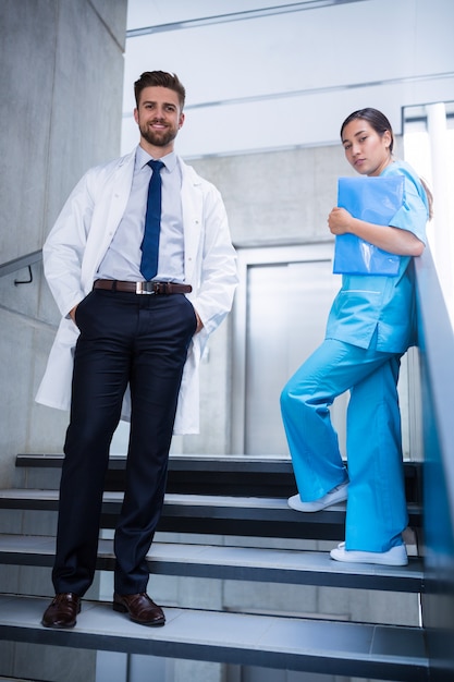 Doctor and nurse standing on staircase