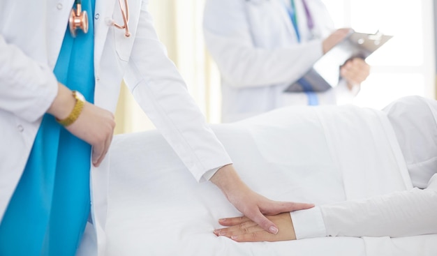 Doctor or nurse talking to patient in hospital