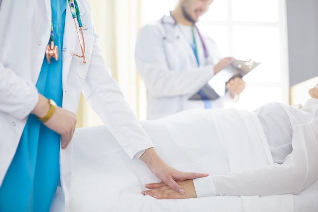 Doctor or nurse talking to patient in hospital