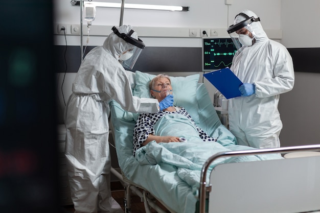 Doctor and nurse wearing cover all ppe suit as prevention