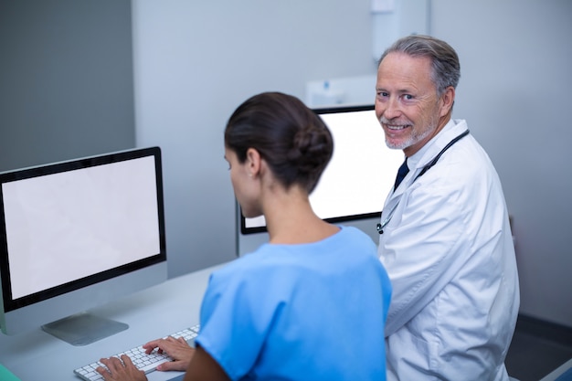 Doctor and nurse working on computer