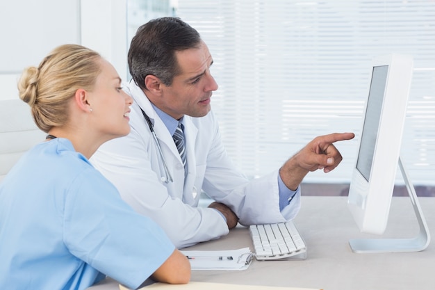 Doctor and nurse working with computer 