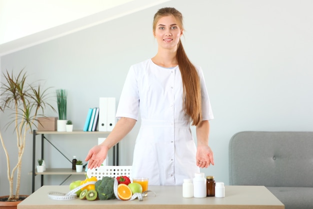 Doctor nutritionist in her office demonstrates the concept of healthy eating