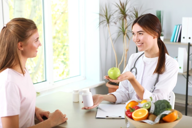 Doctor nutritionist takes a patient in the office proper nutrition