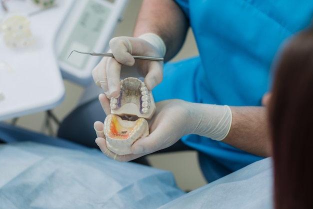 Doctor orthodontist showed how the plate works to flatten teeth on the jaws