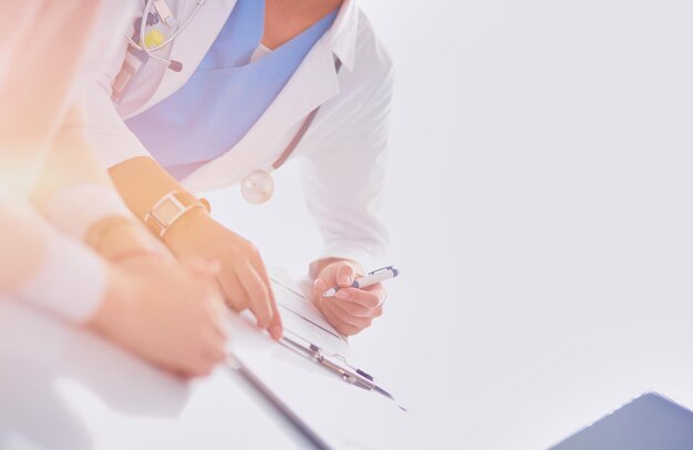 Doctor and patient couple are discussing somethingsitting on the desk