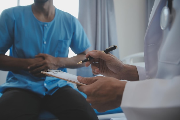 Doctor and patient discussing current health examination while sitting at the desk in clinic office closeup Medicine concept